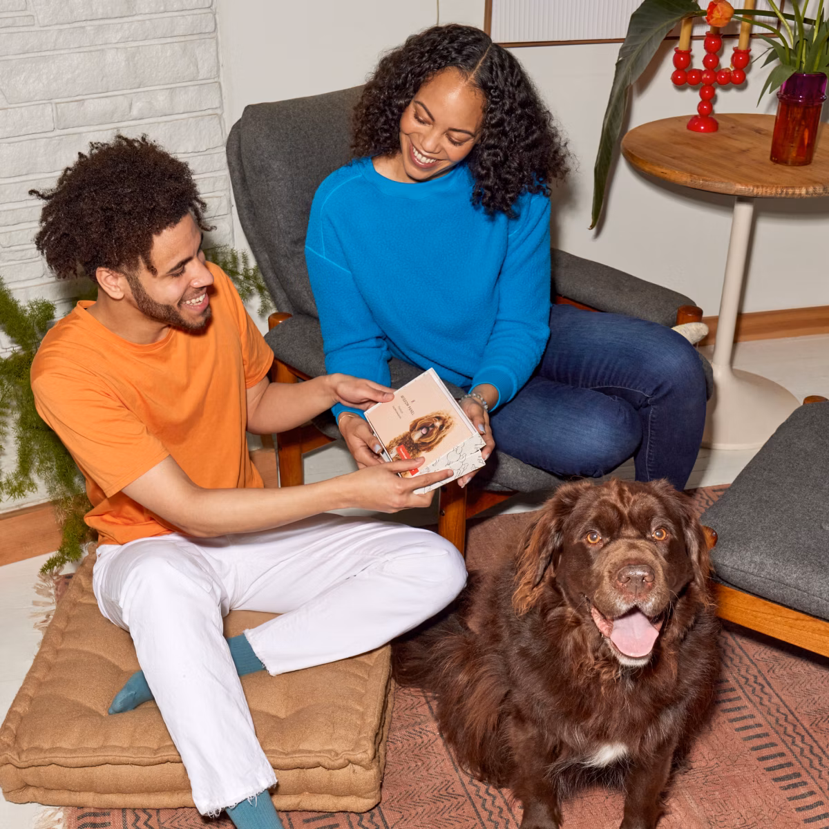 A woman gives a Wisdom Panel pet DNA test as a gift to her partner