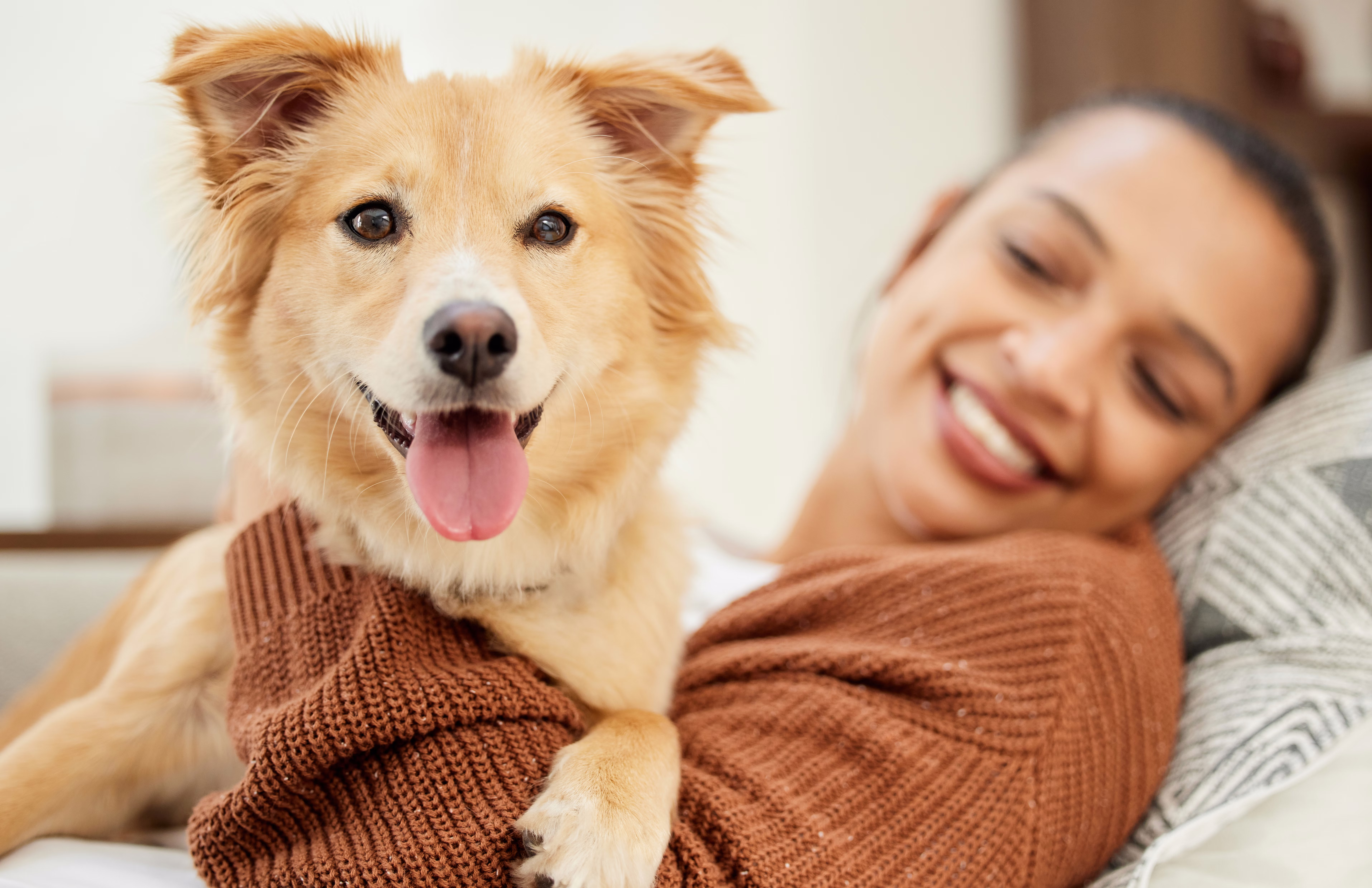 Woman smiling at her dog.